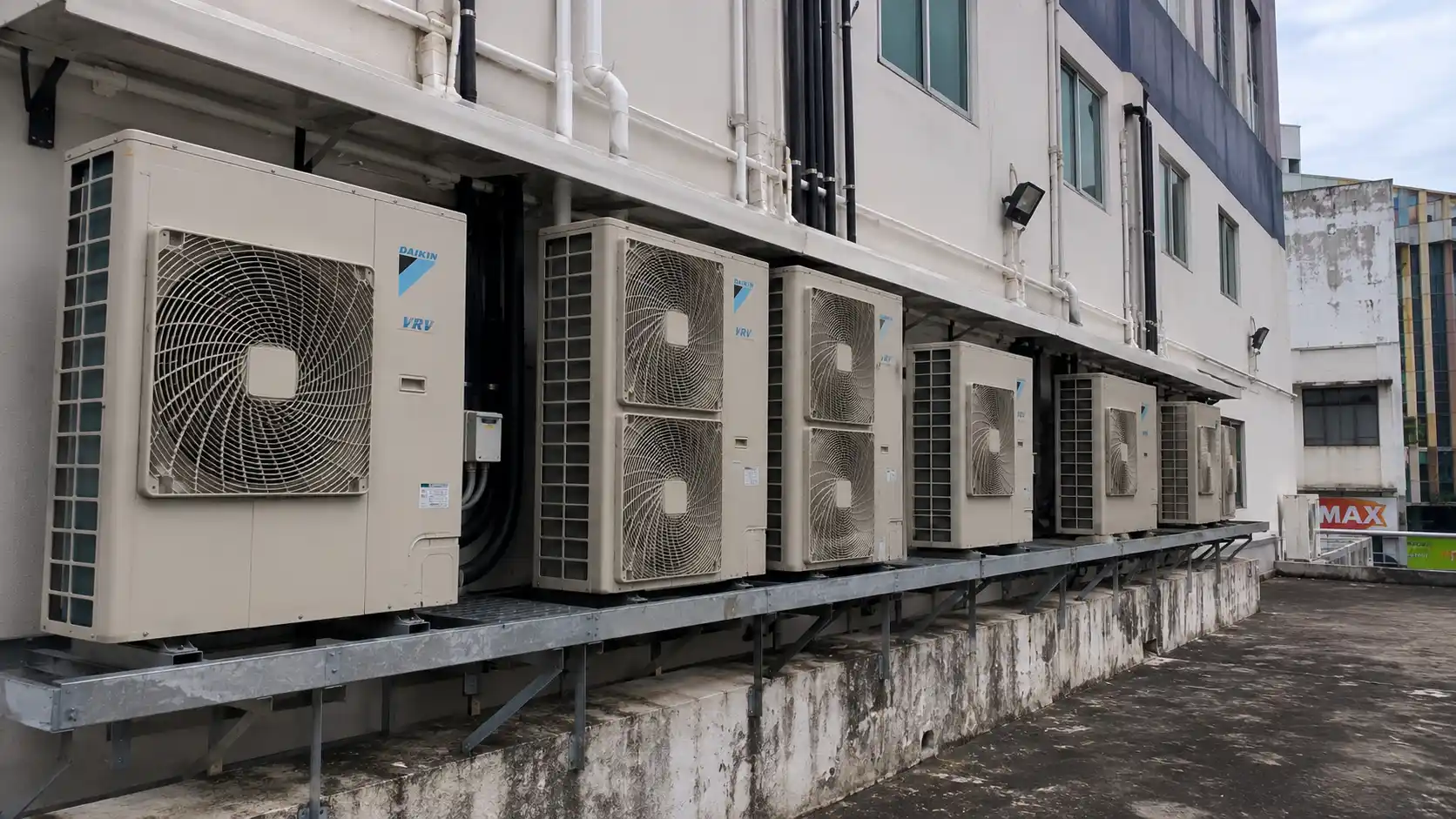 Commercial HVAC outdoor compressor units mounted on a shop lot rooftop or external wall